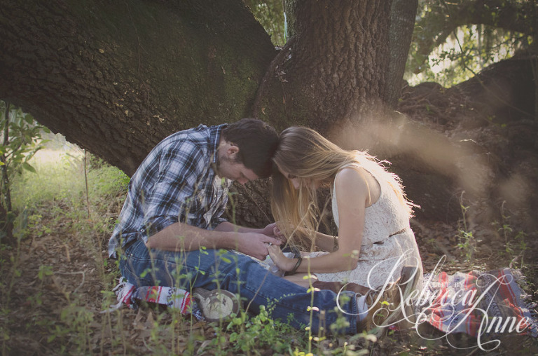 woman, girl, engagement couple, couple, embrace, hug, smile, man, boy, bible, reading, reading bible, country, blanket, pasture, praying, pray