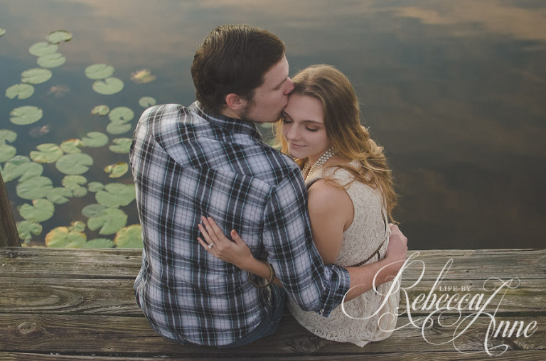 engagement couple, lake, couple, sunrise, smile, back, looking at sunrise, kiss