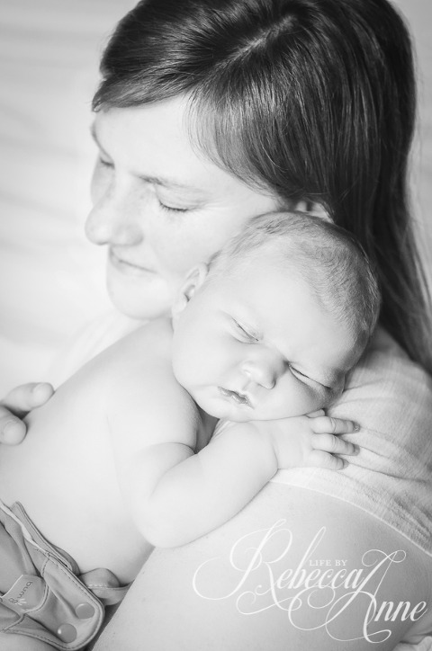 mommy holding newborn, black and white, mommy smile
